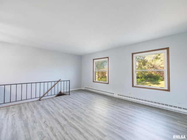 1024 Florence Ave, Pekin, IL 61554 - unfurnished room with a baseboard heating unit, wood finished floors, and baseboards