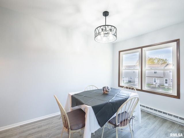 1024 Florence Ave, Pekin, IL 61554 - dining space with a baseboard heating unit, wood finished floors, a chandelier, and baseboards