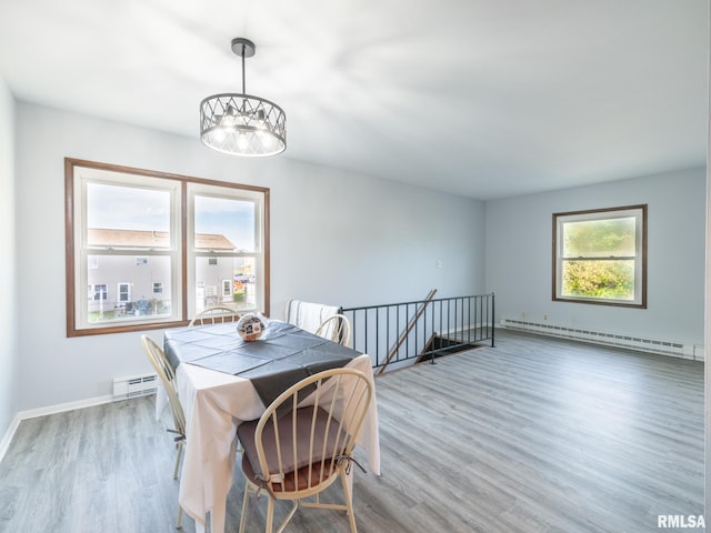 1024 Florence Ave, Pekin, IL 61554 - dining area featuring a baseboard heating unit, wood finished floors, and baseboards