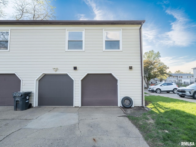 1024 Florence Ave, Pekin, IL 61554 - view of home's exterior with an attached garage, a lawn, and concrete driveway
