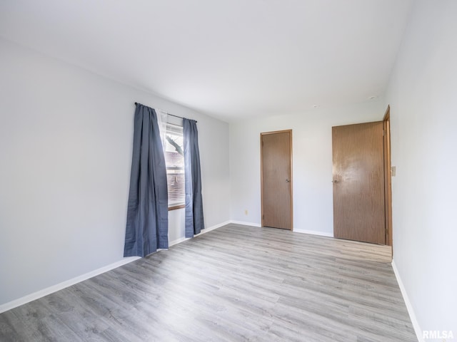 1024 Florence Ave, Pekin, IL 61554 - unfurnished bedroom with light wood-style floors and baseboards