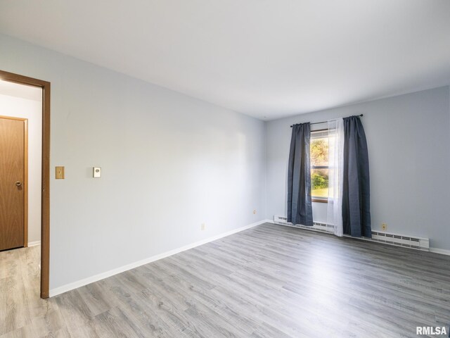 1024 Florence Ave, Pekin, IL 61554 - unfurnished room featuring light wood-style floors, baseboard heating, and baseboards