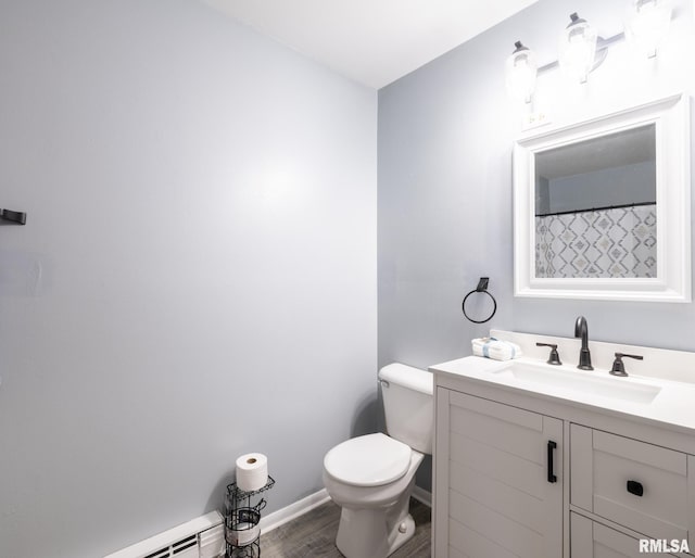 1024 Florence Ave, Pekin, IL 61554 - full bath featuring wood finished floors, toilet, vanity, baseboards, and a baseboard radiator