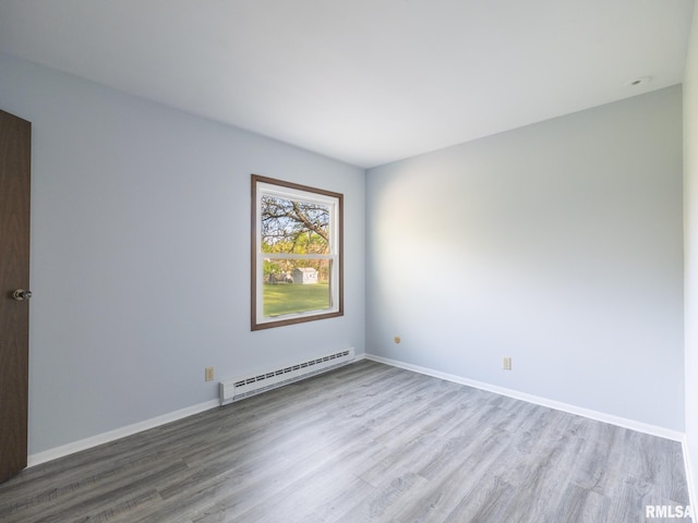 1024 Florence Ave, Pekin, IL 61554 - empty room with a baseboard radiator, wood finished floors, and baseboards