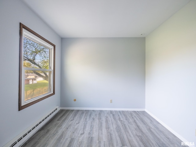 1024 Florence Ave, Pekin, IL 61554 - unfurnished room featuring baseboard heating, light wood-style flooring, and baseboards