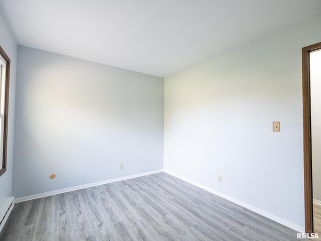 1024 Florence Ave, Pekin, IL 61554 - spare room with wood finished floors, baseboard heating, and baseboards