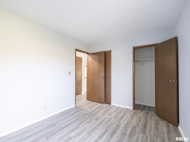 1024 Florence Ave, Pekin, IL 61554 - unfurnished bedroom with light wood-style floors, a closet, and baseboards