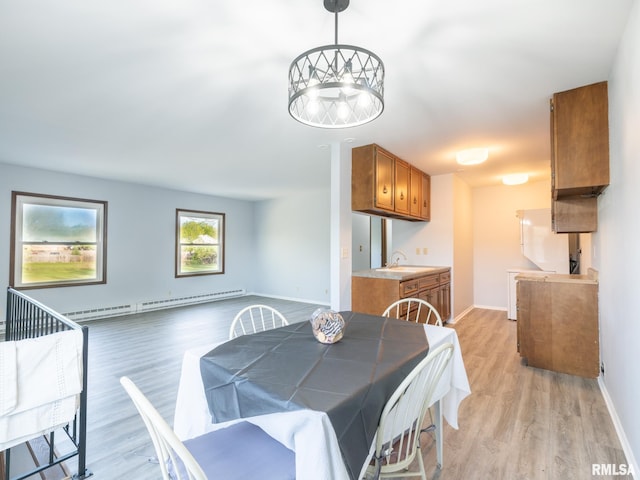 1024 Florence Ave, Pekin, IL 61554 - dining room featuring light wood finished floors, a baseboard radiator, and baseboards
