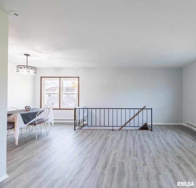 1024 Florence Ave, Pekin, IL 61554 - spare room featuring wood finished floors, baseboards, and a baseboard heating unit