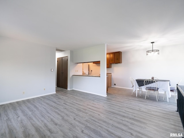 1024 Florence Ave, Pekin, IL 61554 - living area with light wood-style flooring, baseboards, and a chandelier