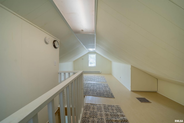 212 S Cone St, Farmington, IL 61531 - additional living space with a baseboard heating unit, visible vents, and lofted ceiling