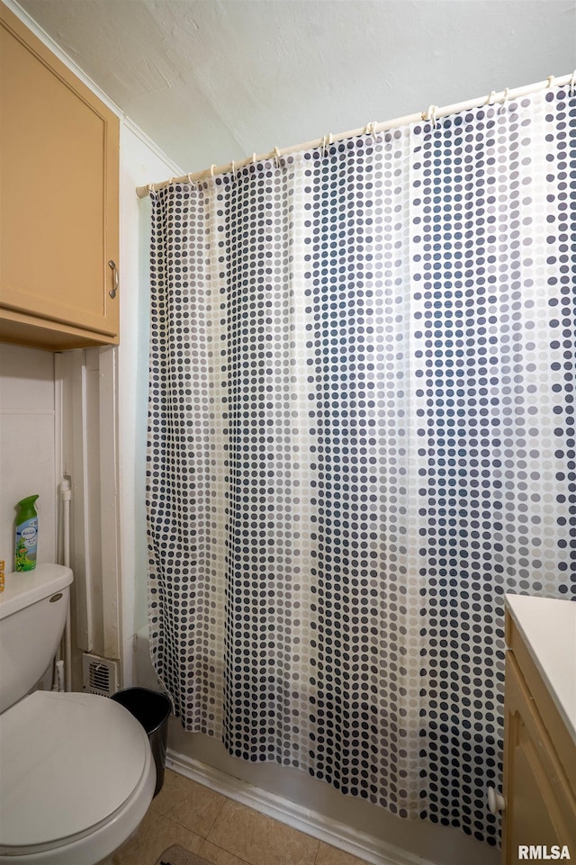 212 S Cone St, Farmington, IL 61531 - full bath with vanity, toilet, shower / tub combo, visible vents, and tile patterned flooring