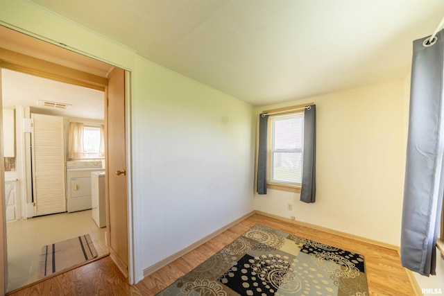212 S Cone St, Farmington, IL 61531 - interior space featuring washer and dryer, visible vents, and wood finished floors