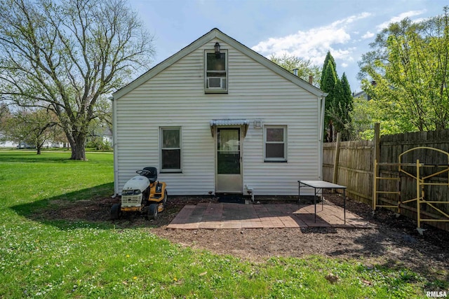 212 S Cone St, Farmington, IL 61531 - rear view of property with a patio, fence, and a yard