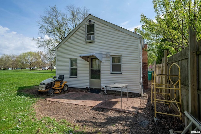 212 S Cone St, Farmington, IL 61531 - back of house featuring a lawn, fence, and a patio area