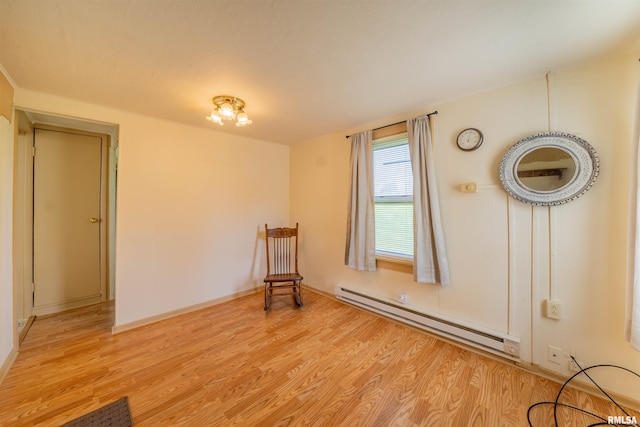 212 S Cone St, Farmington, IL 61531 - unfurnished room with baseboard heating, baseboards, and light wood-style floors