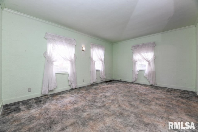 empty room featuring ornamental molding, carpet, and baseboards