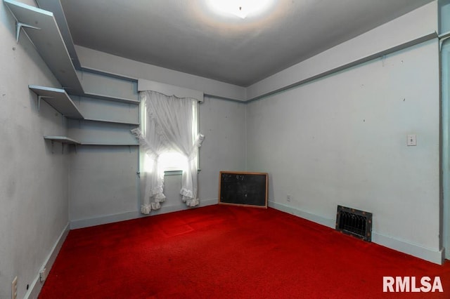 carpeted spare room with baseboards and visible vents