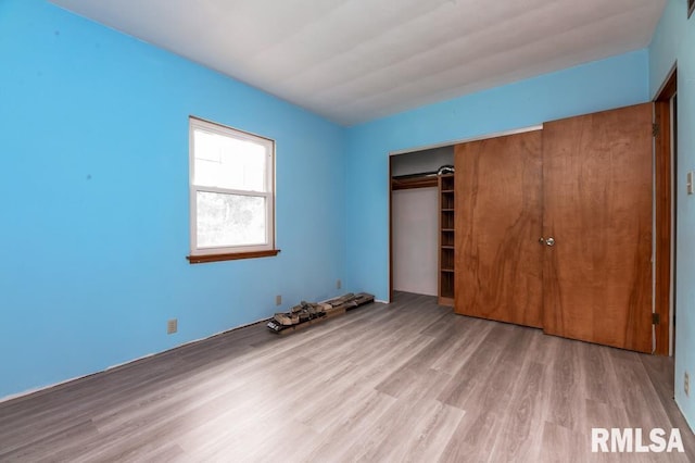 unfurnished bedroom featuring a closet and wood finished floors