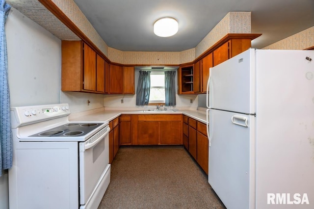 kitchen featuring light countertops, a sink, brown cabinets, and white appliances