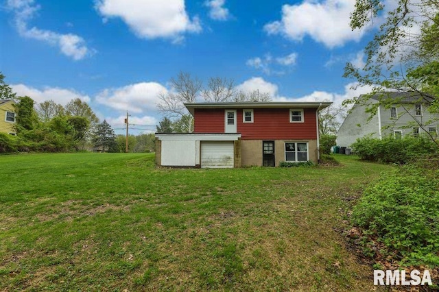 back of house with central AC unit and a lawn