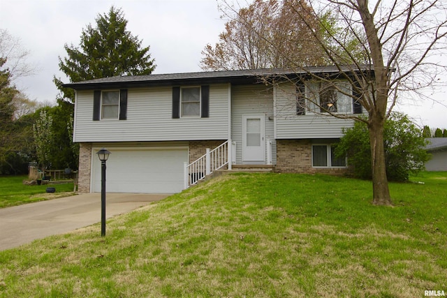bi-level home featuring brick siding, a front yard, concrete driveway, and an attached garage