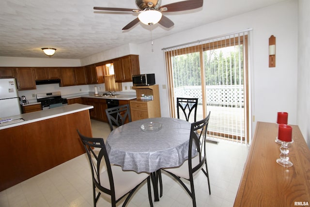 dining room featuring a ceiling fan and light floors