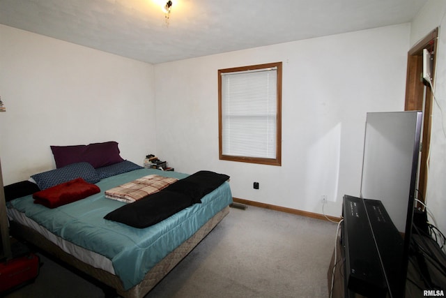 carpeted bedroom featuring visible vents and baseboards