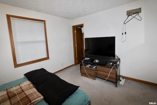 carpeted bedroom featuring baseboards