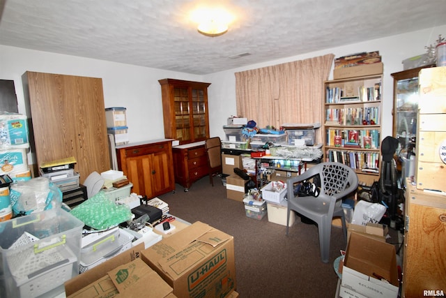 carpeted home office with a textured ceiling