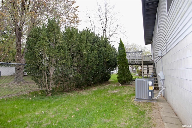 view of yard with fence, stairway, and cooling unit