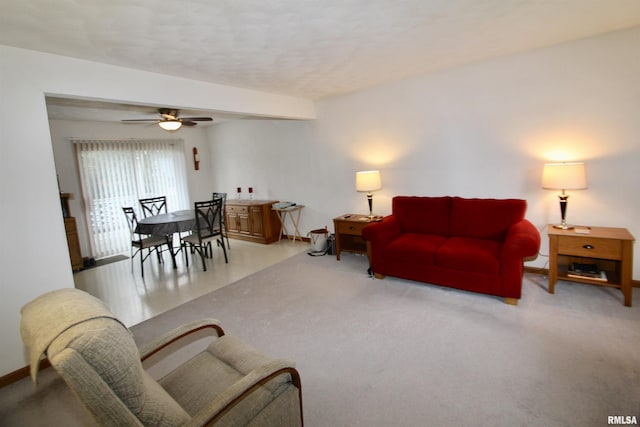 living room featuring a ceiling fan and baseboards