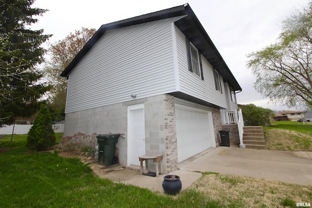view of property exterior with driveway, a yard, and an attached garage