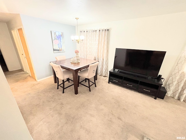 dining area featuring an inviting chandelier and carpet floors