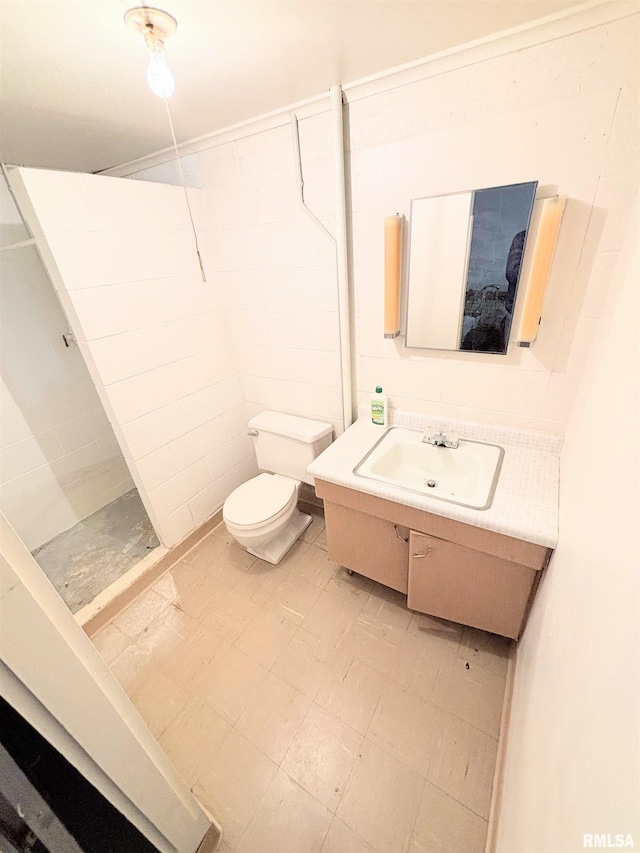 full bathroom with toilet, a stall shower, tile patterned floors, and vanity