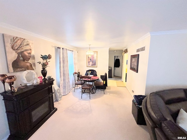 dining room featuring ornamental molding, an inviting chandelier, visible vents, and light colored carpet