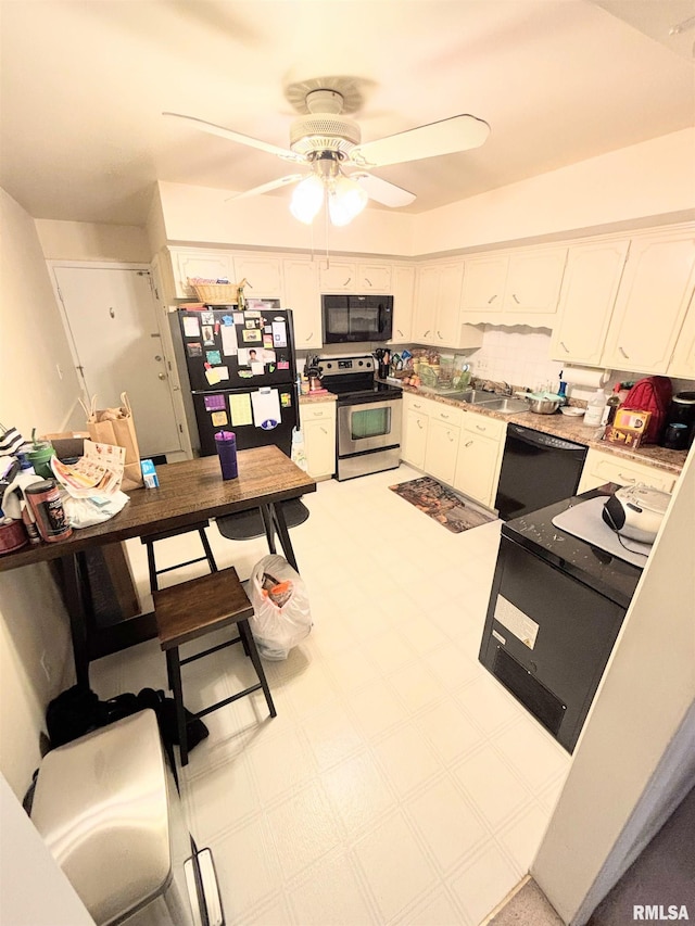kitchen featuring black appliances, a ceiling fan, white cabinetry, and light countertops