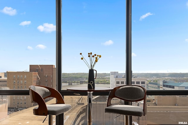 sunroom / solarium with plenty of natural light and a city view