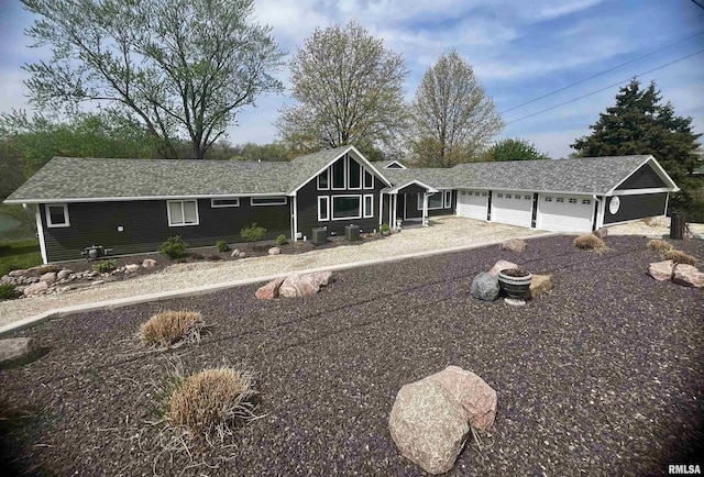view of front of house with a garage and central AC