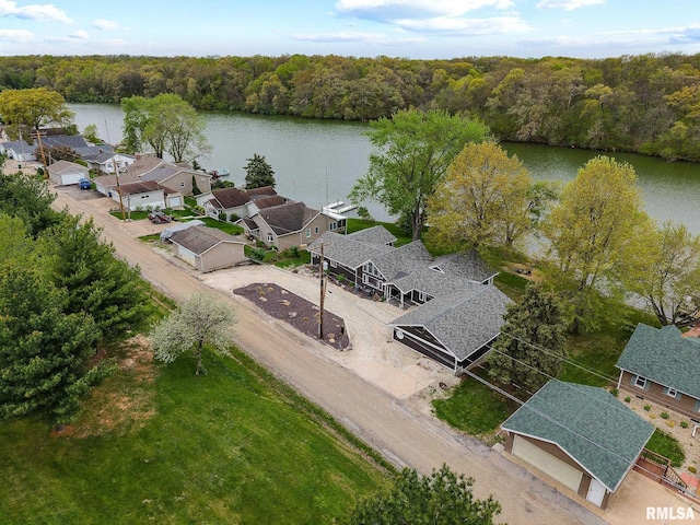 drone / aerial view with a water view and a forest view