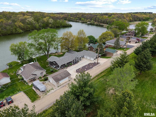drone / aerial view with a water view, a residential view, and a forest view