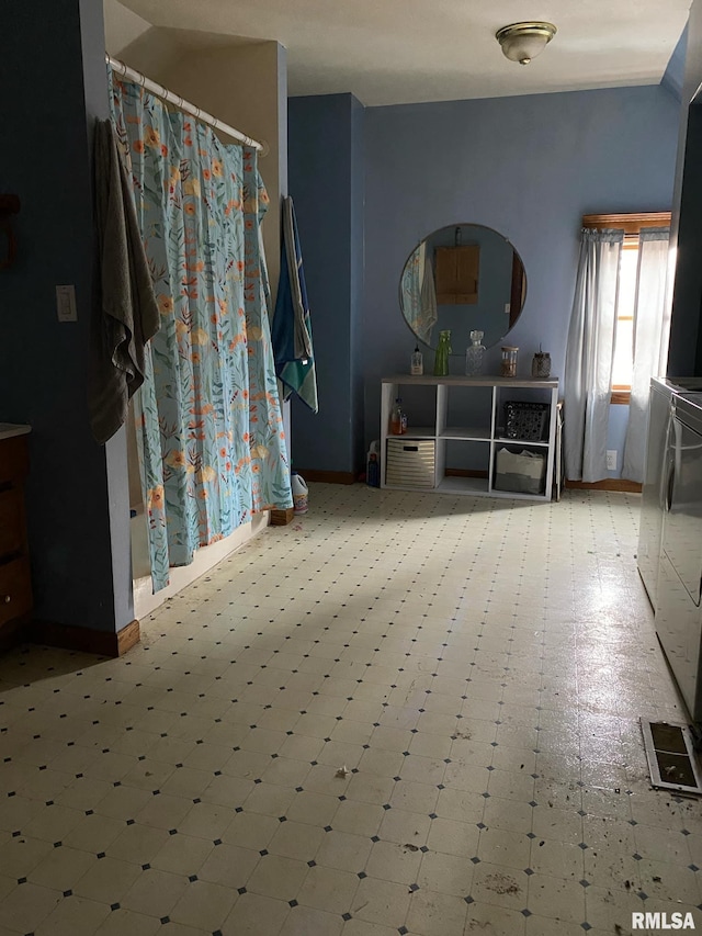 interior space with tile patterned floors and baseboards