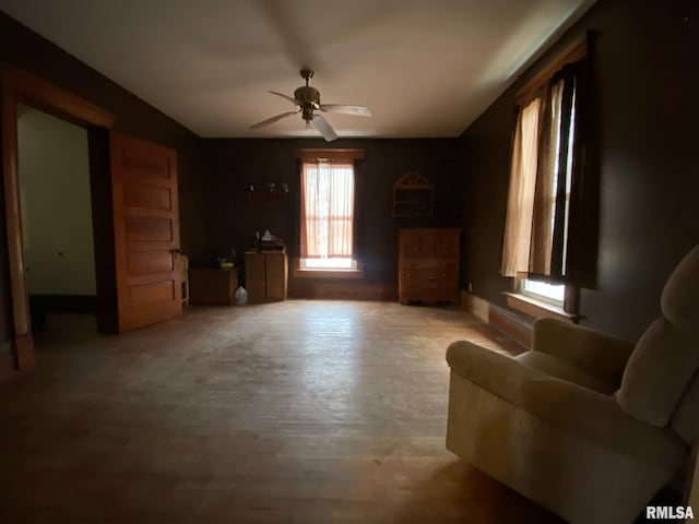 living area with a ceiling fan