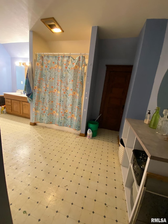 full bath featuring vanity, a shower with shower curtain, and tile patterned floors