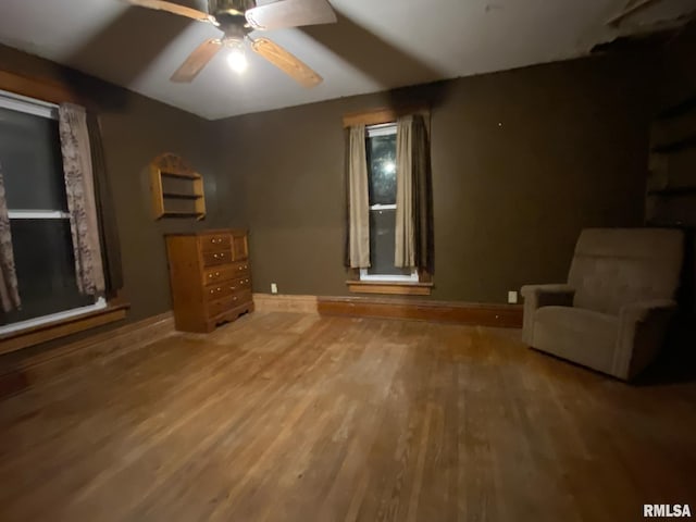 unfurnished room with baseboards, a ceiling fan, and wood finished floors