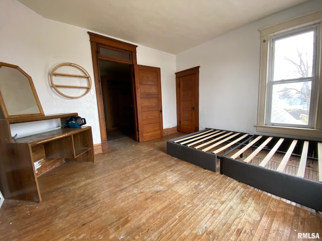 unfurnished bedroom with hardwood / wood-style floors