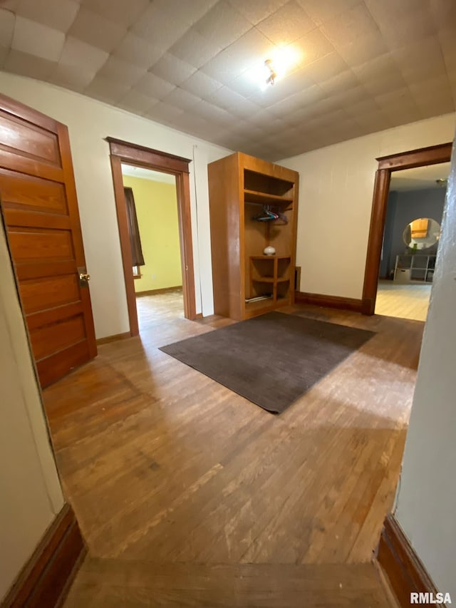 interior space featuring baseboards and wood finished floors