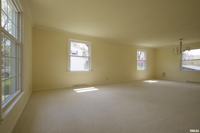 carpeted spare room featuring baseboards, visible vents, a notable chandelier, and crown molding