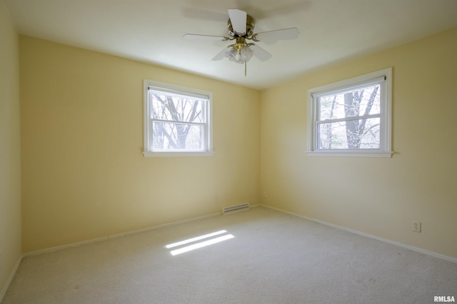 empty room featuring baseboards, visible vents, a ceiling fan, and carpet