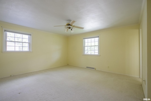 unfurnished room with carpet, ceiling fan, and crown molding